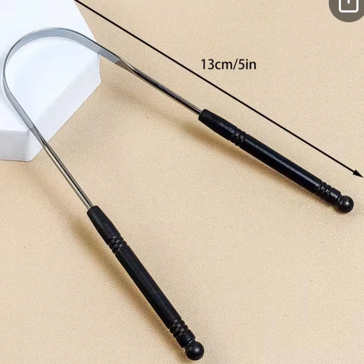 Silver And Black Metal Tongue Scraper