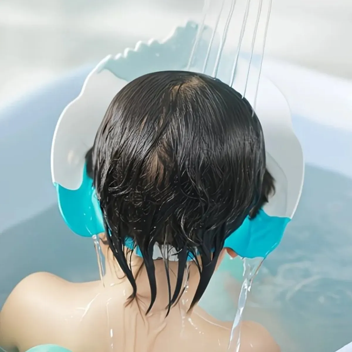 A Shampoo Cap Designed to Prevent Choking And Keep Soap Out of The Eyes, Featuring a Dinosaur Cartoon Design.