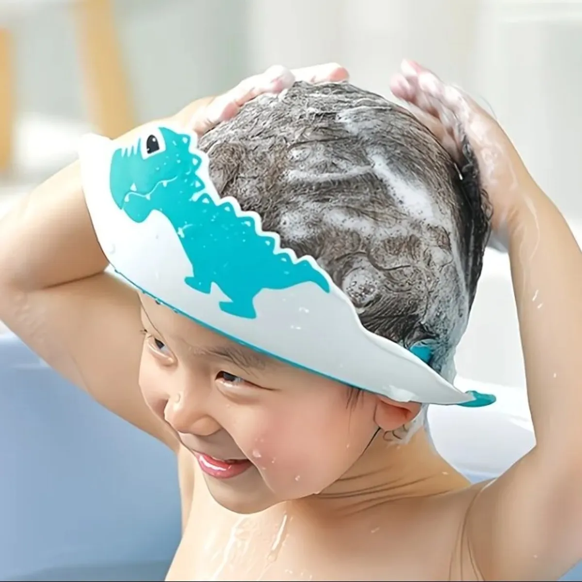 A Shampoo Cap Designed to Prevent Choking And Keep Soap Out of The Eyes, Featuring a Dinosaur Cartoon Design.
