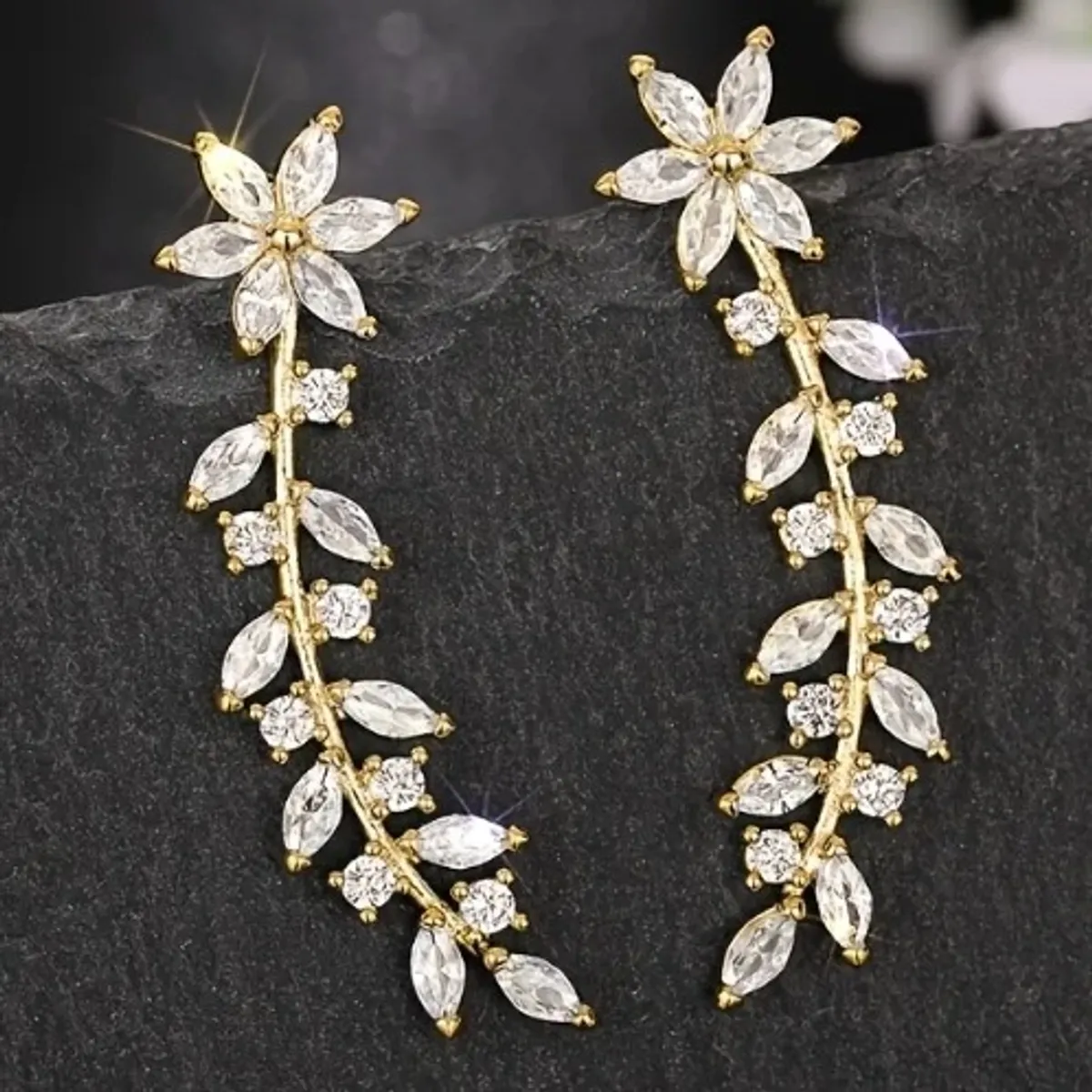 A Set of Sophisticated And Opulent Earrings Adorned with Floral, Leafy, And Wheat Designs