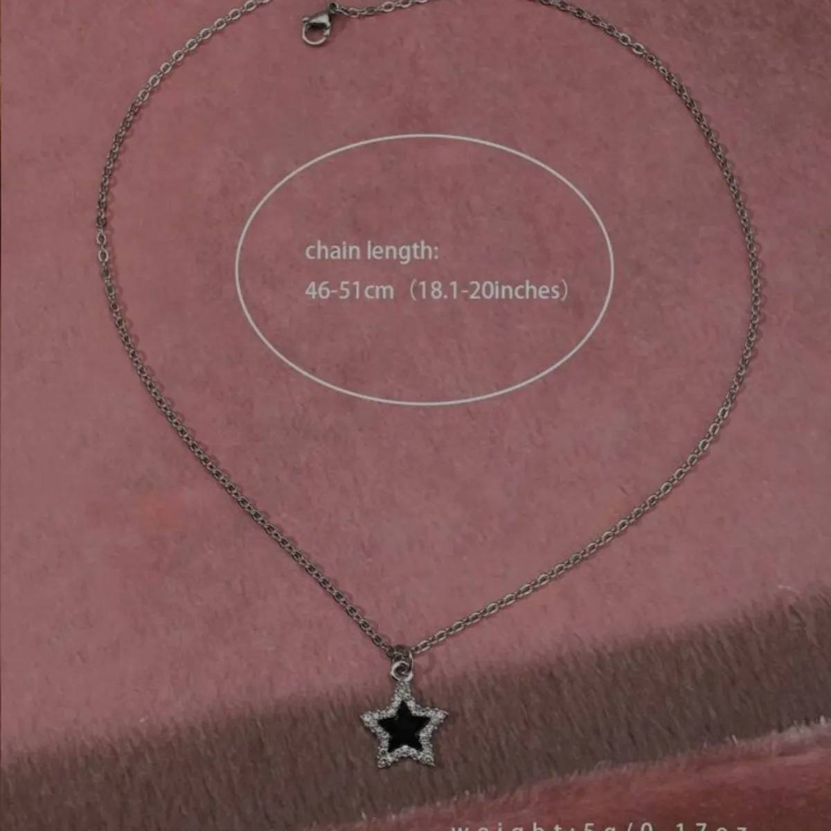 Silver-tone star Necklace features a black Enamel Center surrounded by small clear stones
