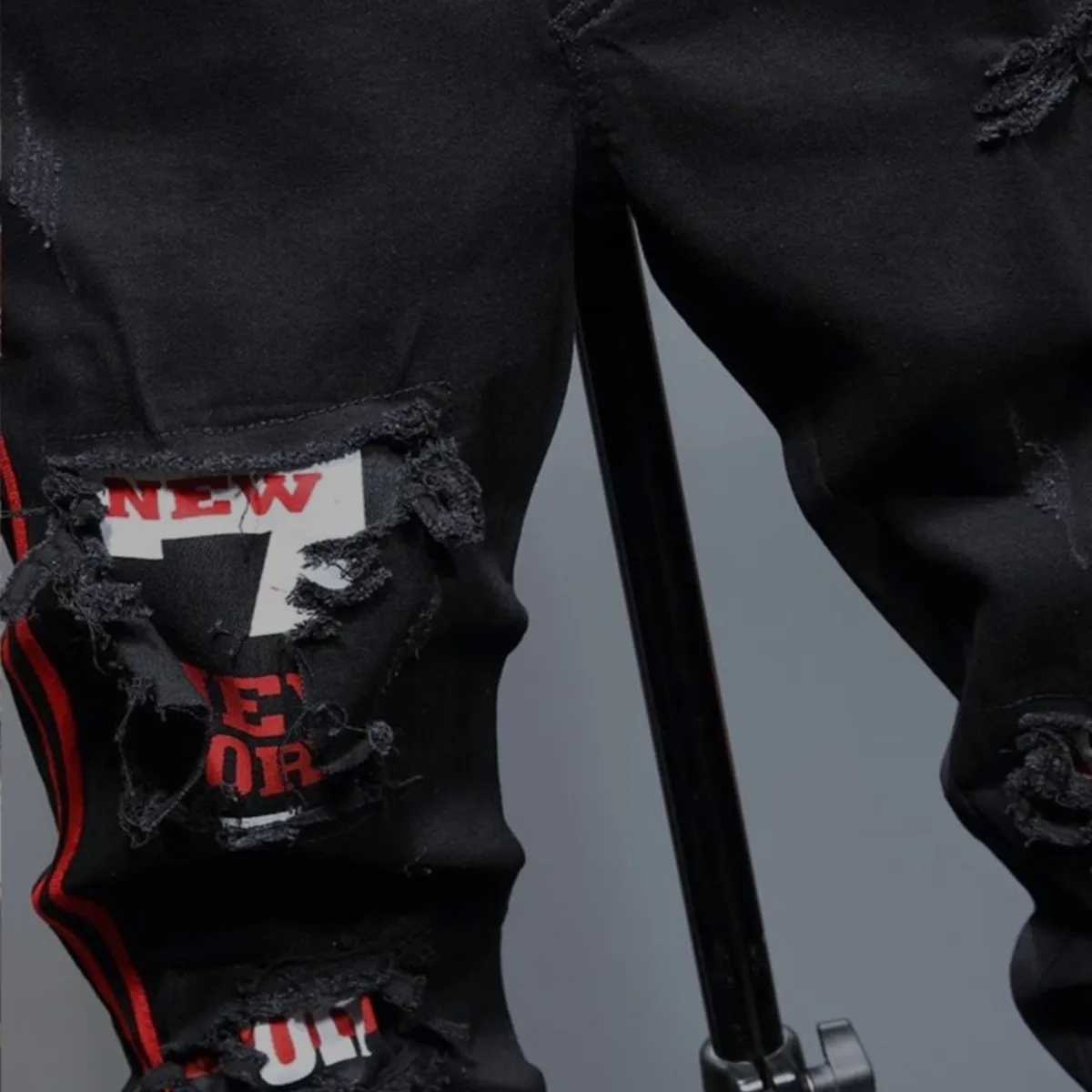 Men's Black Ripped jeans feature Distinctive Red side stripes and "New York" patches-Size 28